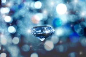 Glowing diamond on bokeh background photo