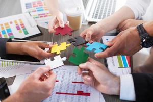 Teamwork of partners. Concept of integration and startup with puzzle pieces photo