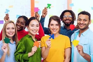 Teamwork of partners that work together. Concept of integration and startup with colored puzzle pieces photo