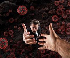 Hopeless businessman needs help because he is surrounded by viruses and bacteria. Concept of pandemic photo