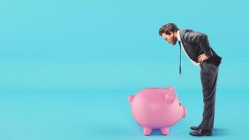 Man looks inside the piggy bank looking for money photo