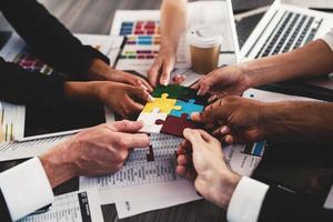 Teamwork of partners. Concept of integration and startup with puzzle pieces photo