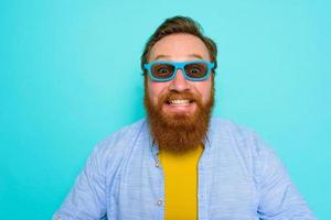 Man with beard and sunglasses is very happy photo