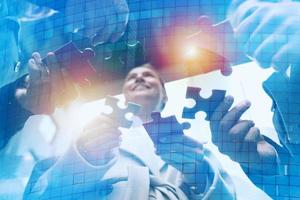 Teamwork of partners. Concept of integration and startup with puzzle pieces photo