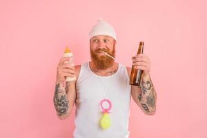 Hungry man with beard and tattoos acts like a newborn but wants a beer photo