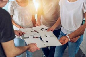 Teamwork of partners connect puzzle pieces as integration and startup photo