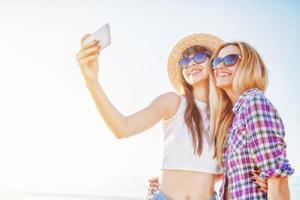Happy group of friend makes a selfie with a mobile phone. photo