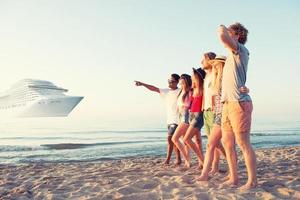 Group of happy friends having fun at ocean beach. Travel with cruiseship concept photo