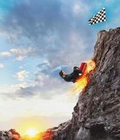 Fast businesswoman with a car climbs a mountain to reach the flag. Concept of success and competition. photo
