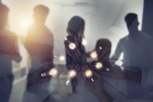 Teamwork and brainstorming concept with businessmen that share an idea with a lamp. Concept of startup. Double exposure photo