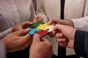 Teamwork of partners. Concept of integration and startup with puzzle pieces photo