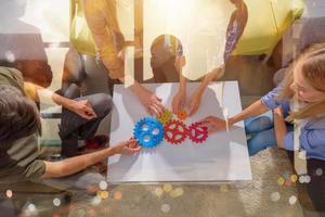 Business team connect pieces of gears like a teamwork and partners photo