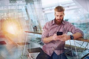 Businessman works in office with a smartphone connected on internet network photo
