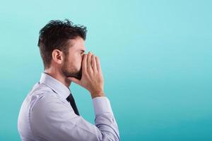 Man talks secretly covering his mouth with the hand photo