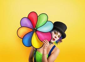 Clown with colored helix on yellow background photo