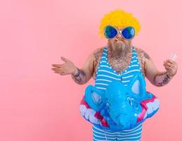 Fat doubter man with beard and wig smokes cigarettes photo