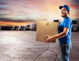 Courier ready to deliver packages with truck photo