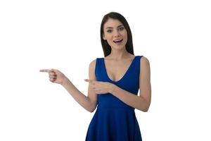 Surprised girl indicates a blank space for your text. Isolated on white background photo