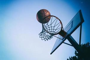 Ball enters the basket in an outdoor playing field photo