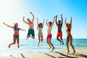 Group of friends having fun on the beach photo