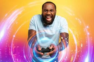 Happy man plays with a videogame on red background photo