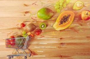 Shopping cart full of fresh fruit ready to deliver photo