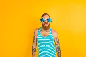 man with beard,tattoos and swimsuit is ready for the summer photo