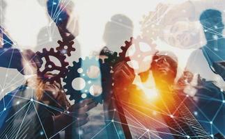 Business team connect pieces of gears. Teamwork, partnership and integration concept with network effect. double exposure photo