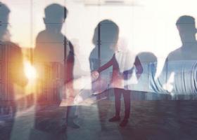 Handshaking business person in office. concept of teamwork and partnership. double exposure photo