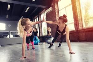 Two friend at the gym doing pushup photo