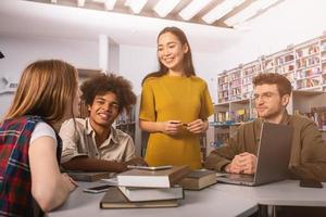 University students are studying in a library together. Concept of teamwork and preparation photo