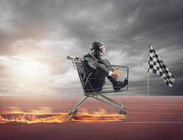 Businessman runs fast driving a cart on fire during a competition photo