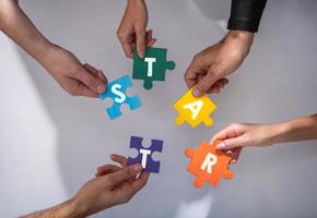 Teamwork of partners. Concept of integration and startup with puzzle pieces photo