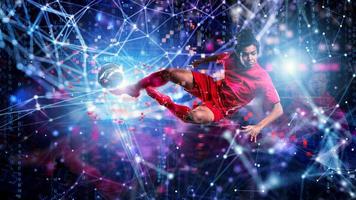 Jumping soccer player kick a ball. Internet background. Concept of bet online photo