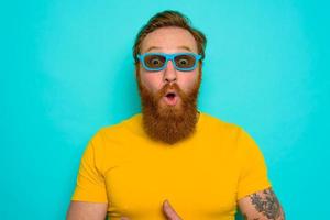 Man with beard and sunglasses is wondered and happy photo