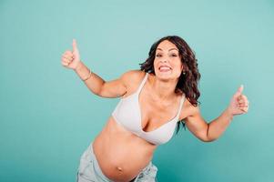 Pregnant happy woman expecting a child caresses her belly photo