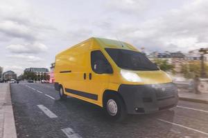 Transportation service with a yellow van moving fast on the road photo