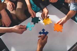 Teamwork of partners connect puzzle pieces as integration and startup photo