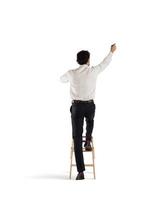 Businessman on a ladder photo