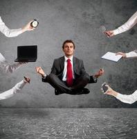Relaxed businessman that does yoga during the work photo