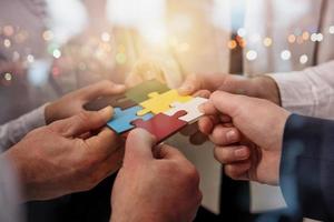 Teamwork of partners. Concept of integration and startup with puzzle pieces photo