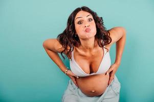 Pregnant woman expecting a child caresses her belly photo