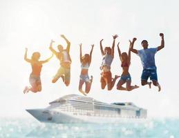 Happy smiling couples playing at the beach with cruiseship in the sea photo