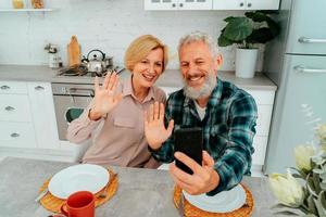 couple greets friends with a video call during breakfast photo