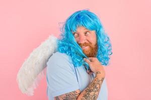 Happy man with beard and blue peruke acts like an agel with wings photo