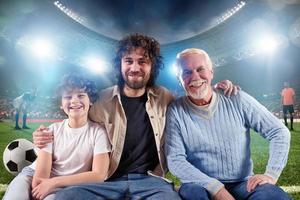 Grandfather, father e grandchild that watch a live streaming soccer match photo