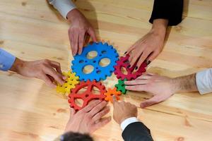 Business team connect pieces of gears like a teamwork and partners photo