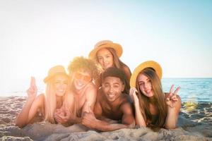 Group of friends having fun on the beach photo