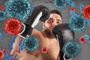 Man fights like a boxer. Concept of viruses and bacteria attack photo