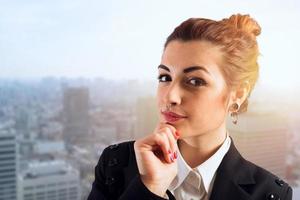 Confident businesswoman thinks about a decision to take photo